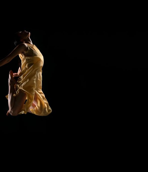 Woman in a dynamic and fluid motion pose, feeling vibrant.